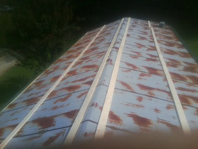 Rusted metal roof panels with new wood purlins before replacement — Storm Damage Roof Repair in Fort Eustis by Roofing Brothers
